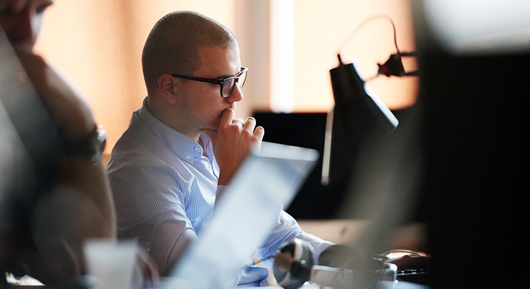 Young business professional using laptop in office