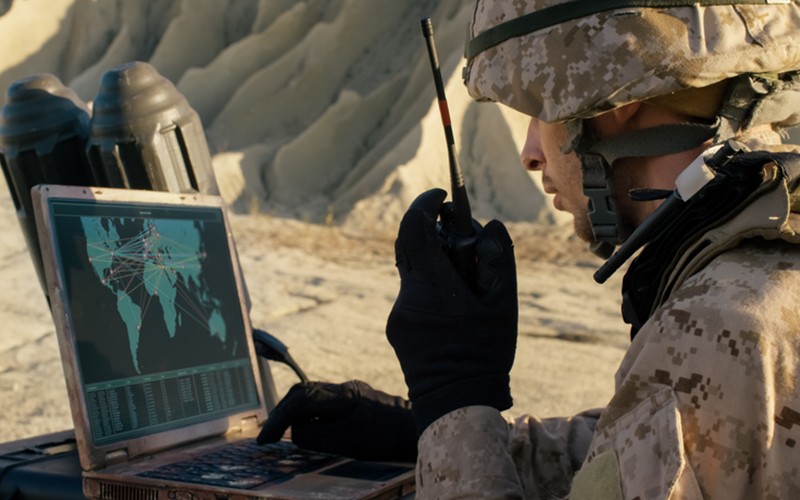 Military person using military technology in field