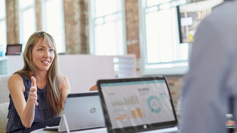 business professionals have discussion near HP devices