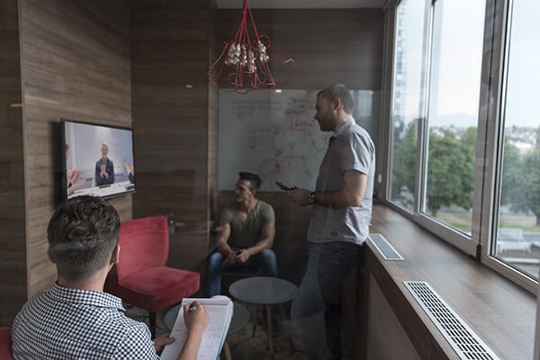 Build your mobile strategy Group of people in business meeting using surface hub