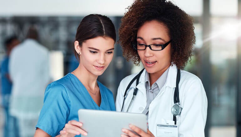 Healthcare professionals watching webinar on tablet device