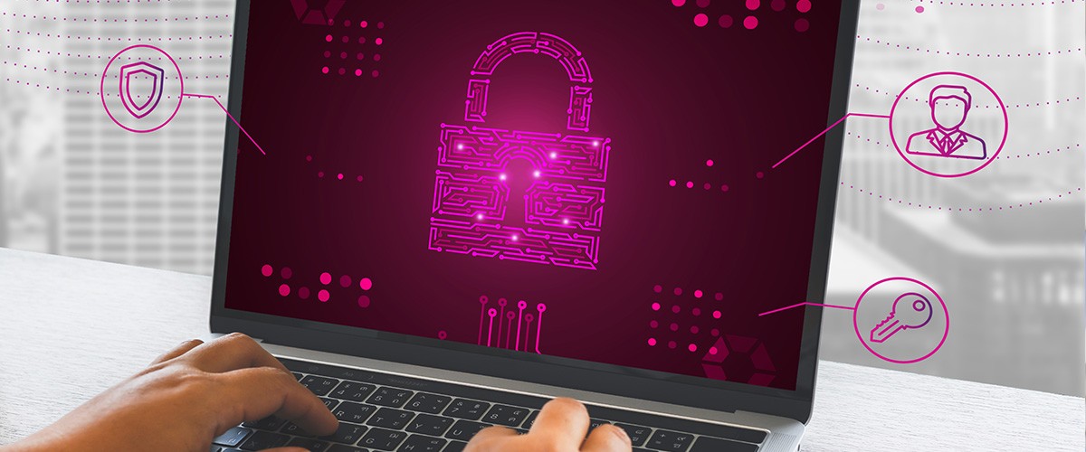 Man using laptop with security graphics on display