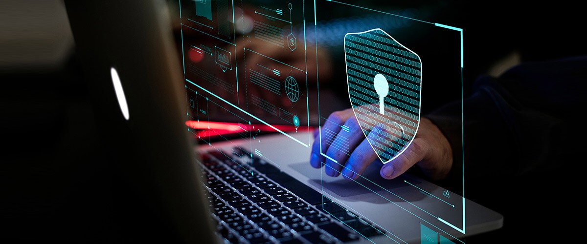 Hand typing on secure laptop