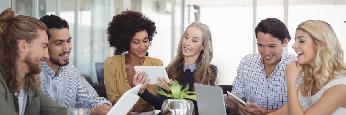 Happy colleagues working on devices