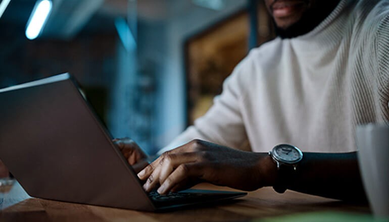 Business professional working off laptop computer. Microsoft Azure, Azure Sentinel, cloud native security, cloud security, SIEM, SOAR, enterprise security, cybersecurity, threat detection, threat prevention