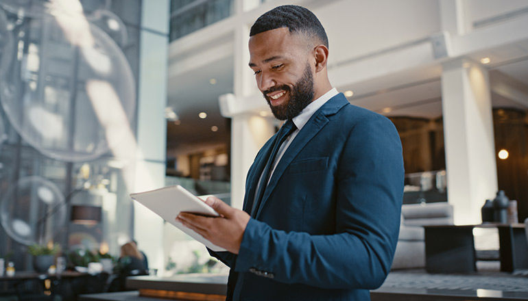 Businessman looking over material in hotel lobby