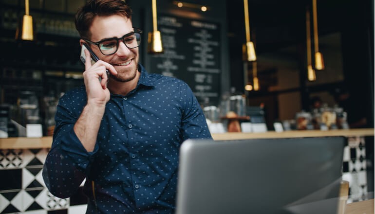 Male employee using technology in store 