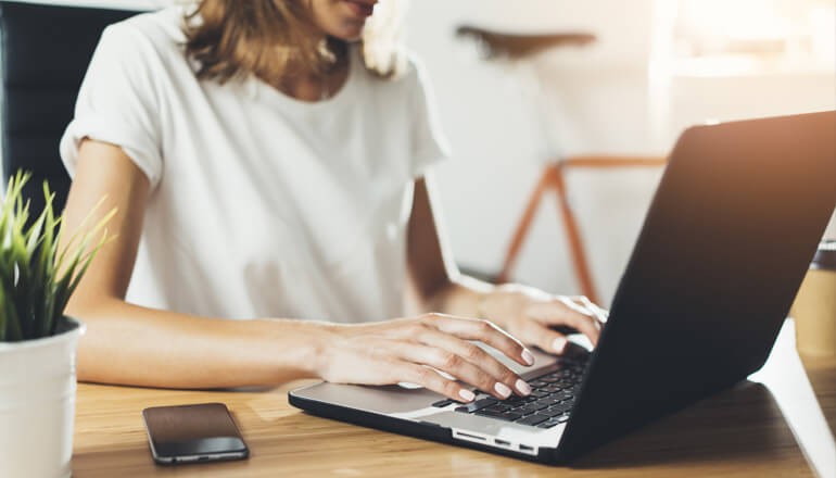 User on laptop at home