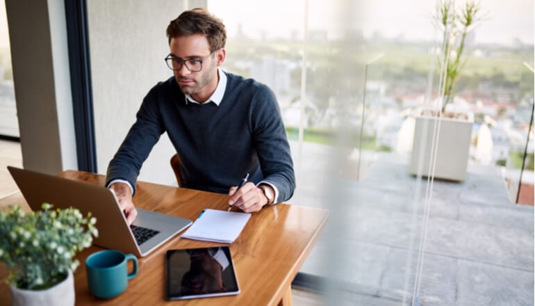 Man using laptop for work at home