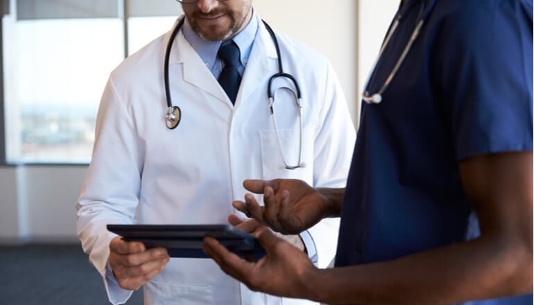 Doctors using tablet device