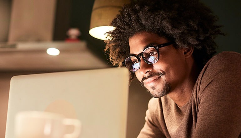 Business professional on virtual call with team. Best practices for working from home webinar.