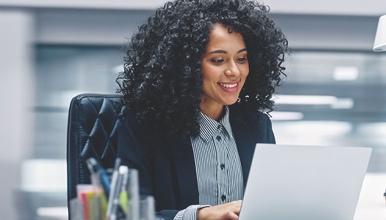 Businesswoman using Windows 11 on laptop device