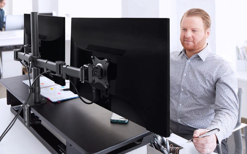 Man using 3M Precision Standing Desks