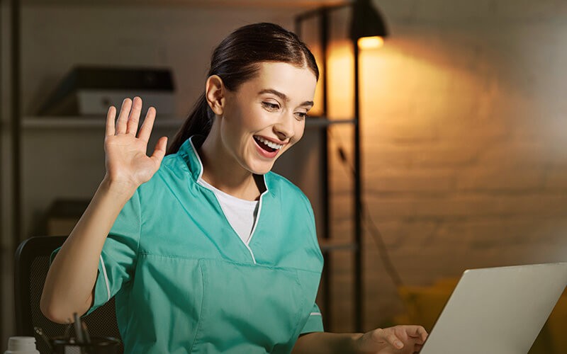 Nurse having online meeting using laptop