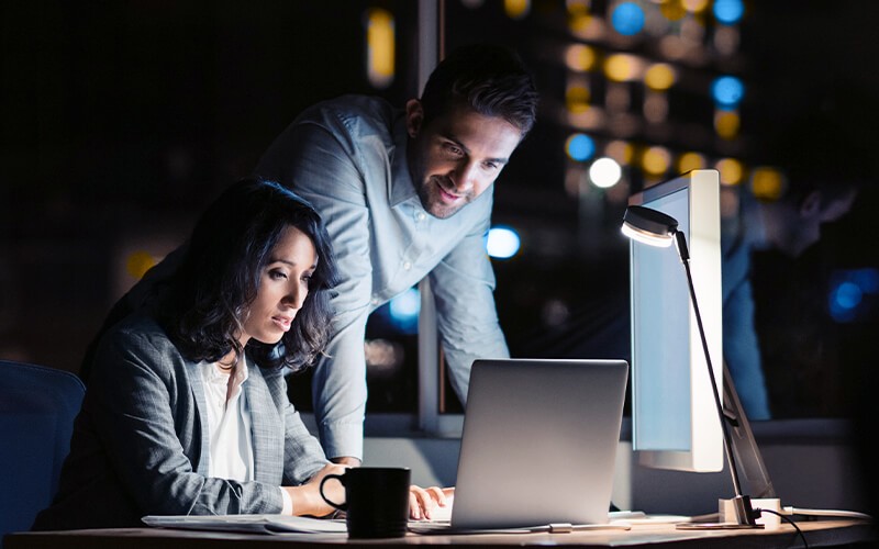 Teammates working together at the office late at night