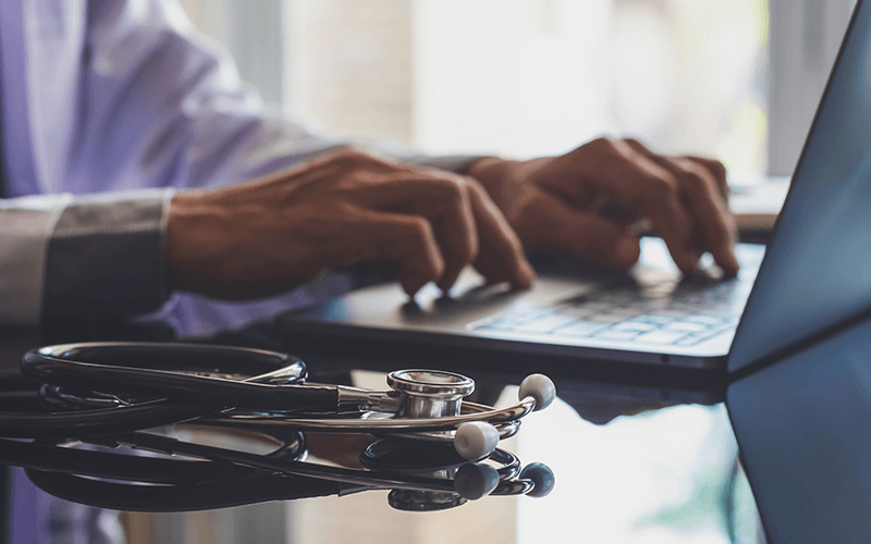 Doctor using his laptop
