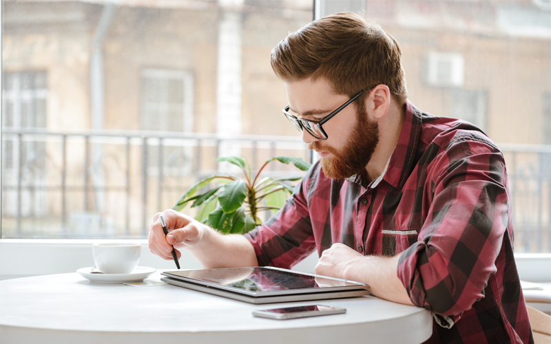 Man using stylus on tablet device