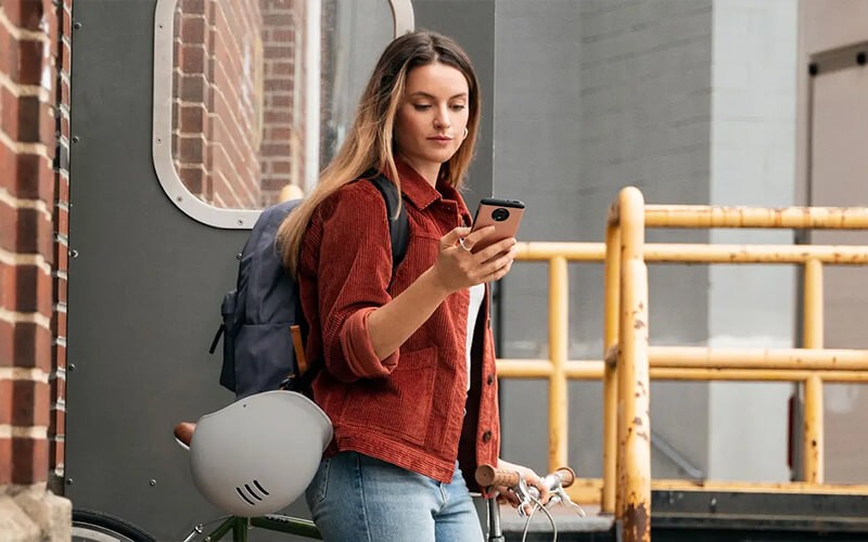 Woman using her smart phone outside