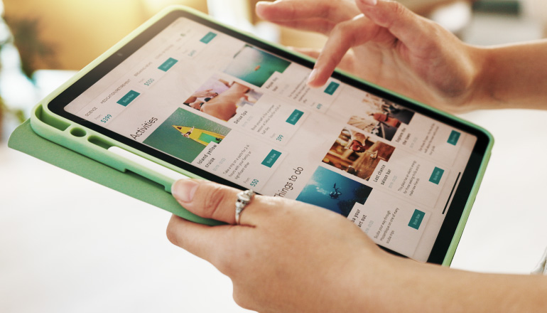 Hand on tablet clicking through available apps.
