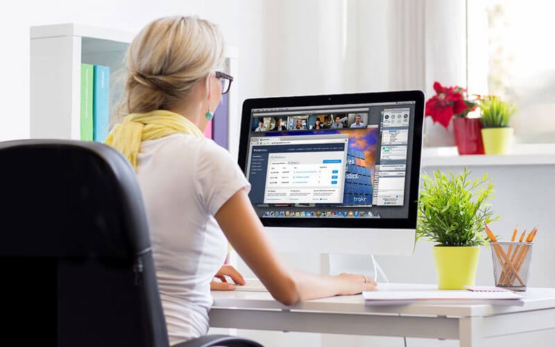 Woman working at open desk with laptop