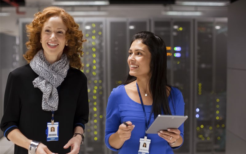 Two women smiling in data center