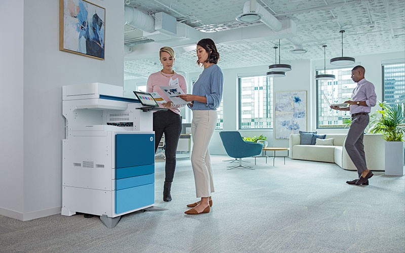 The services and supplies to keep your printer, and your business, churning. Two females printing from HP printer in office