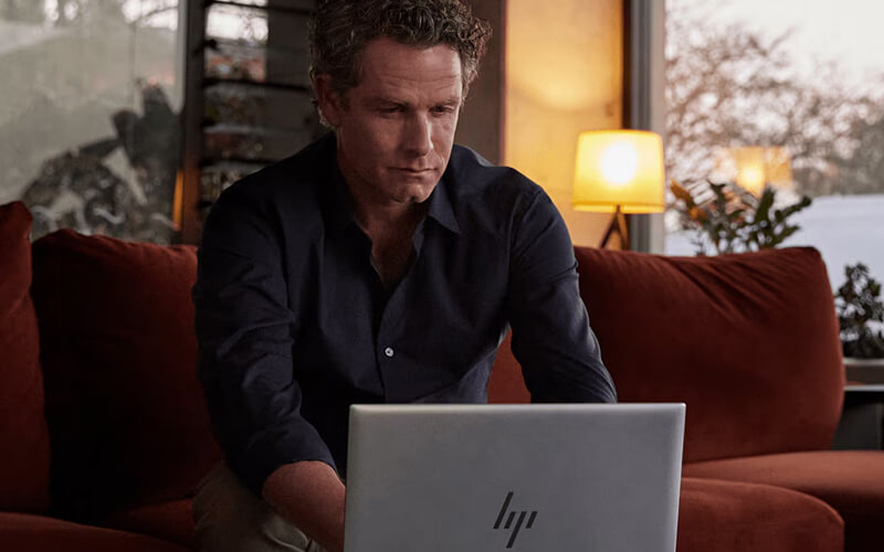 Guy on hp laptop working