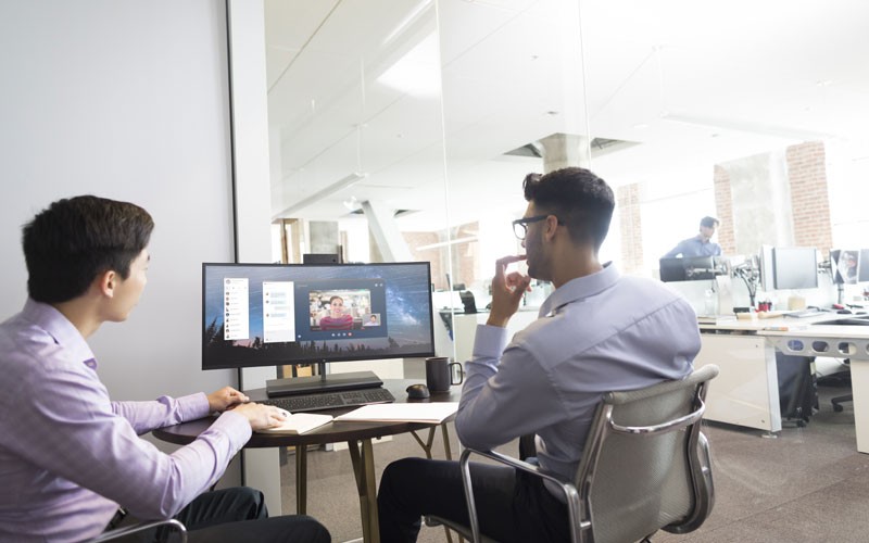 Two men working on HP devices