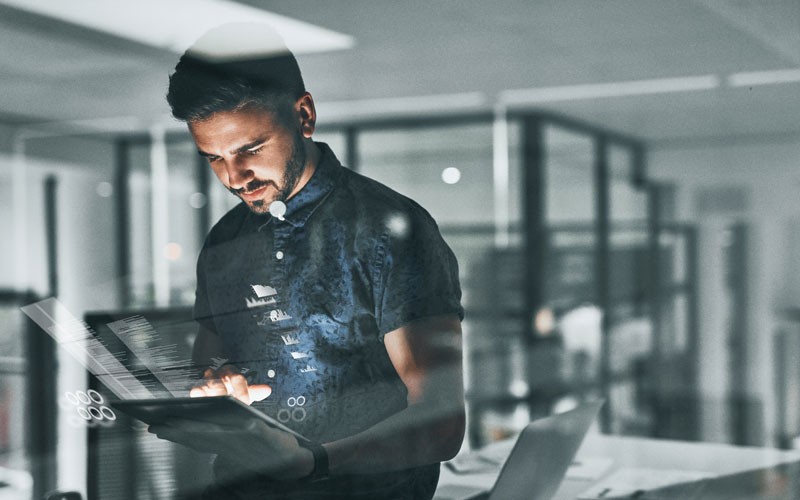 man-working-on-tablet-device-with-graphic-overlay
