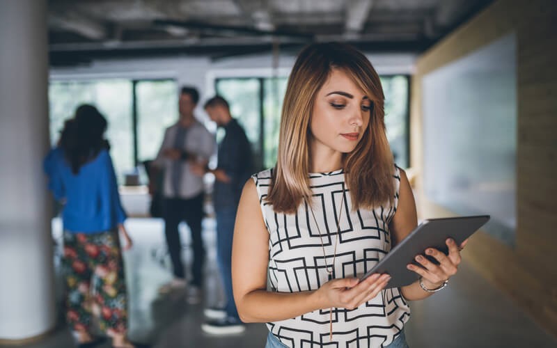 Woman holding tablet in office