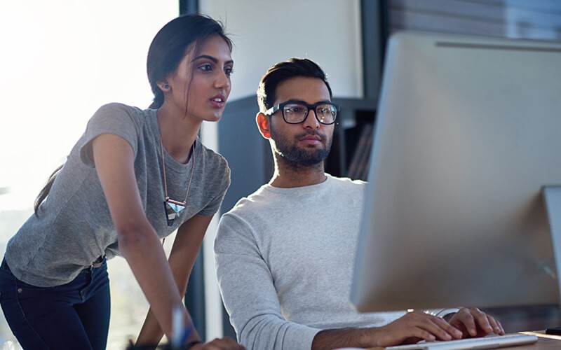 Two users looking at desktop