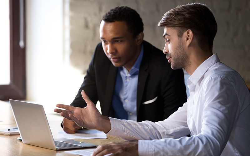Employees discussion using laptop