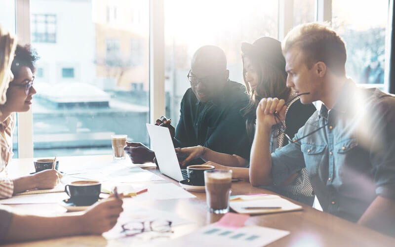 Group of employees working together in remote office