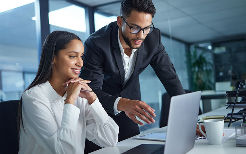 Turn AI power into security outcomes. Teammates working together at the office