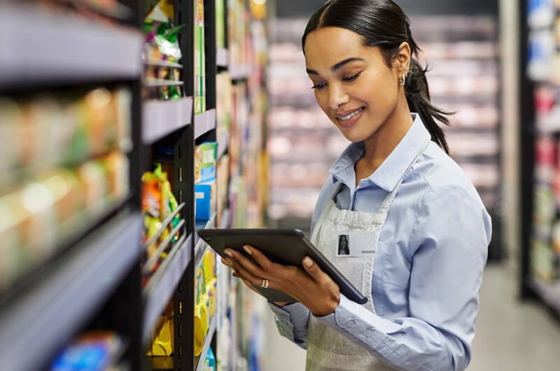 Female employee using tablet at work in modern supermarket