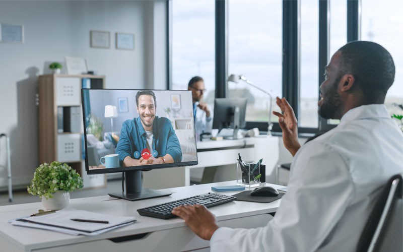 Doctor using computer in telehealth consultation