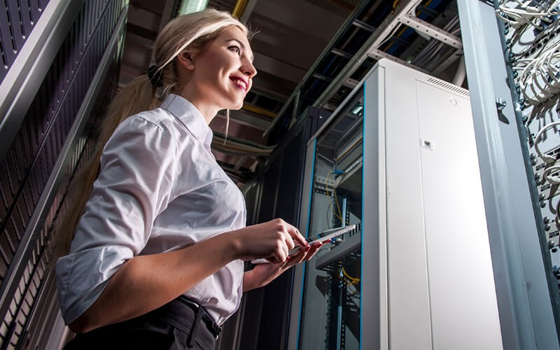 IT engineer in data center evaluating infrastructure