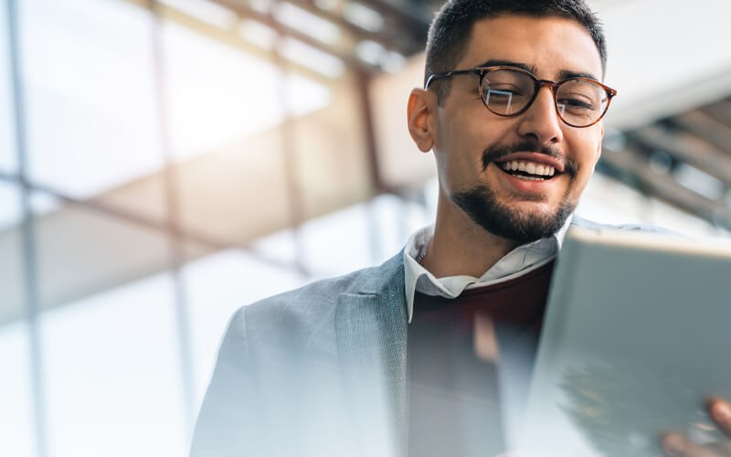Businesswoman in glasses reviews security assessment on computer